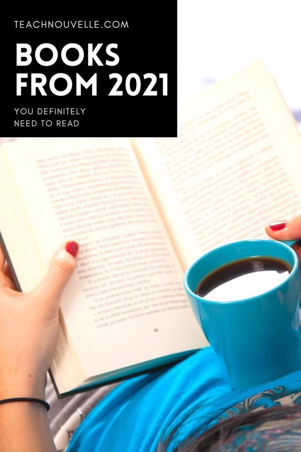 An over-the-shoulder photo of a woman reading a book and holding a blue coffee mug filled with coffee. In the top left of the image there is a black box with white text that reads "Books from 2021 you definitely need to read"