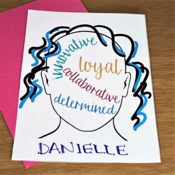A white piece of paper with the outline of a head with black and blue hair, inside the shape of the head are the words "innovative, loyal, collaborative, determined" and the name Danielle written at the bottom in purple ink.