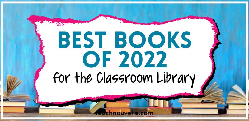 A photo of books stacked in front of a blue wall. In the center of the image there is a white rectangle with blue and black text that reads "Best YA Books of 2022 for the Classroom Library"
