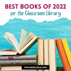 A photo of books in front of a blue wall. At the top of the image there is a white border and pink and blue text that says "Best YA Books of 2022 for the Classroom Library"