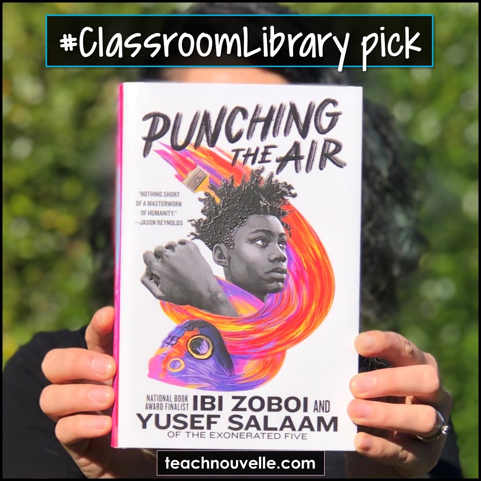 A photo of a woman holding up a copy of the book Punching the Air by Ibi Zboi and Yusef Salaam.